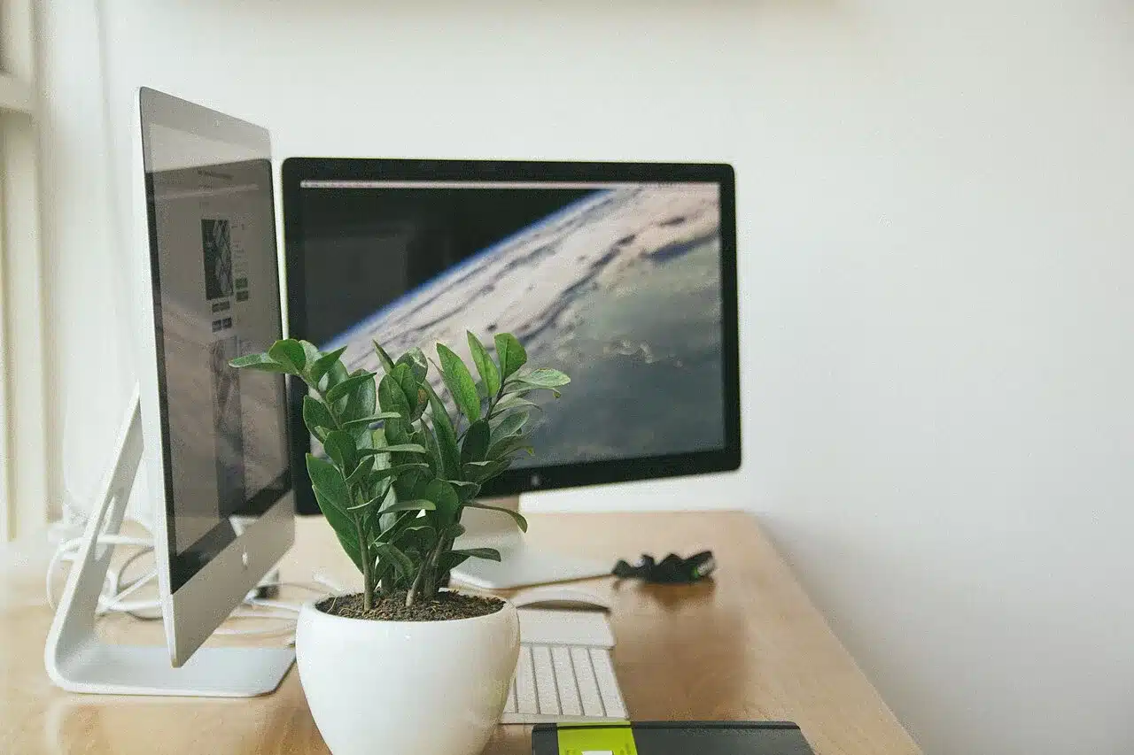 A desk workspace with computer monitors, portable second screen setup