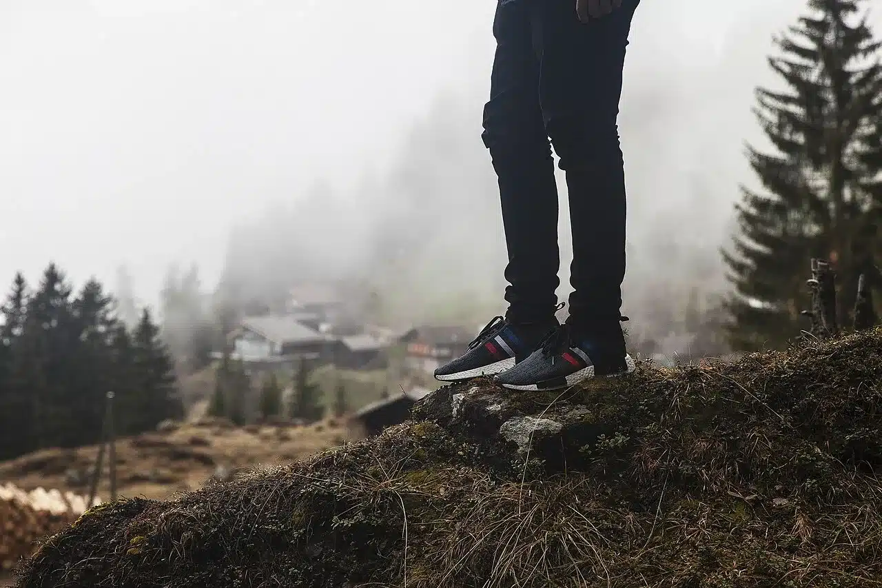 Close up of walking shoes and legs mid step outdoors